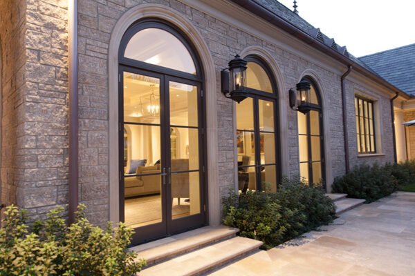 Low profile steel arched doors harlequin stone wing by Solara Custom Living