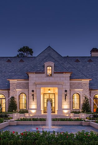 Low profile steel doors lighting estate at dusk by Solara Custom Living
