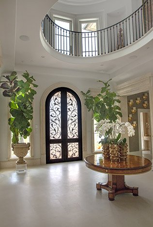 Classic iron arched double door round foyer by Solara Custom Living