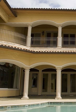 Classic iron balcony railing pool courtyard by Solara Custom Living