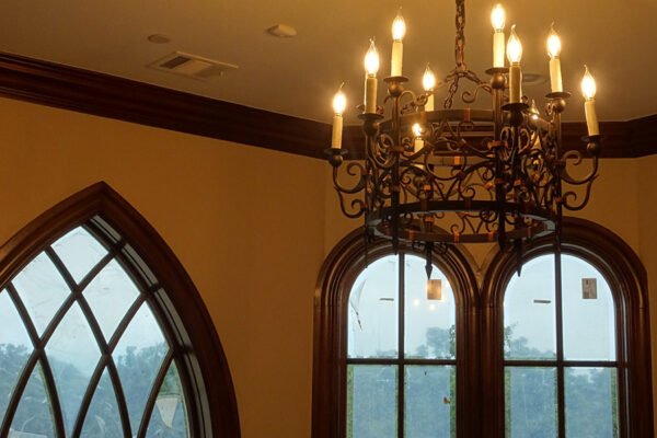 Classic iron chandelier gothic arched windows by Solara Custom Living