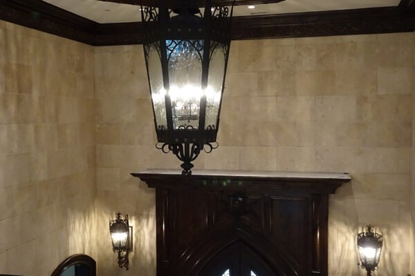 Classic iron lantern pendant and sconces foyer by Solara Custom Living
