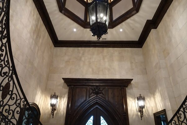 Classic iron lantern sconces and stair railing foyer by Solara Custom Living