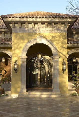 Classic steel alessandria wall lantern arched stone entry by Solara Custom Living