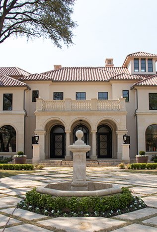Classic steel arched doors courtyard fountain facade by Solara Custom Living