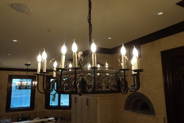 Classic wrought iron candle chandelier great room by Solara Custom Living