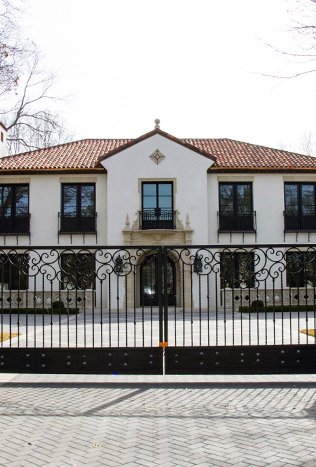 Classic wrought iron driveway gate and fence by Solara Custom Living