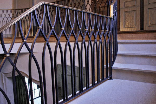Custom steel arched stair railing detail by Solara Custom Living