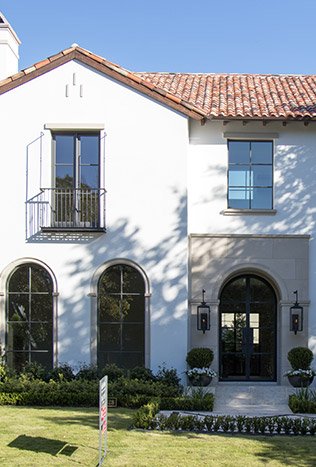 Low profile steel arched doors spanish colonial home by Solara Custom Living