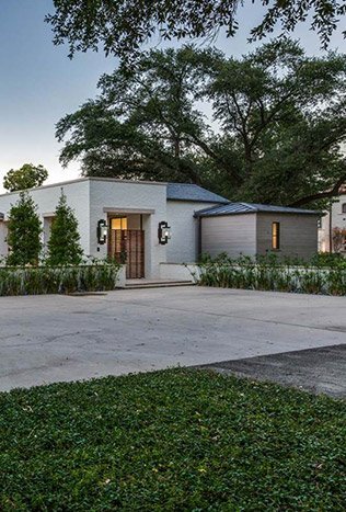 Low profile steel doors lighting modern home by Solara Custom Living