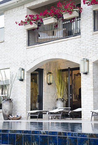 Low profile steel doors wall lanterns pool terrace by Solara Custom Living