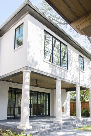 Low profile steel doors windows two story home by Solara Custom Living