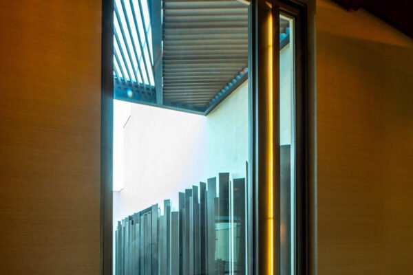 Low profile steel pivot door open view by Solara Custom Living