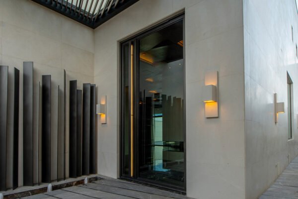 Low profile steel pivot entry door pergola by Solara Custom Living