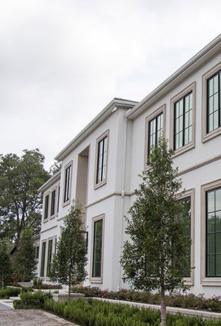 Low profile steel windows transitional stone home by Solara Custom Living