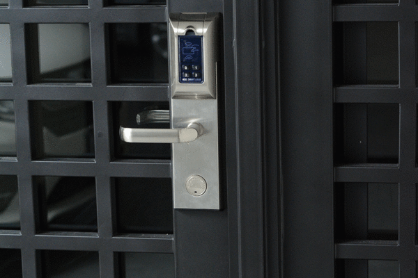 Modern steel barragan grid door smart lock detail by Solara Custom Living