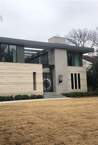 Modern steel entry doors travertine facade by Solara Custom Living