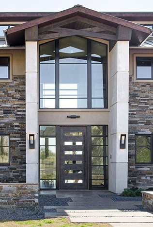 Modern steel pivot entry door glass transom by Solara Custom Living