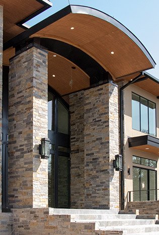 Transitional steel entry door stone portico by Solara Custom Living