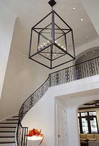 Transitional steel geometric pendant curved stair by Solara Custom Living
