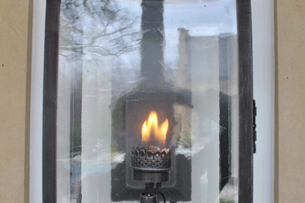 Transitional steel wall lantern flame detail by Solara Custom Living