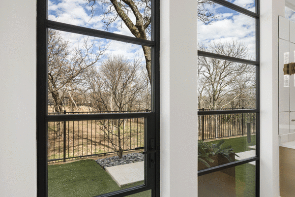 Jansen steel divided lite doors open to terrace by Solara Custom Living